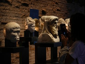 A visitor admires archeological finds in the domus Tiberiana during the press preview on Rome's Palatine Hill on Sept. 20, a day before the reopening.