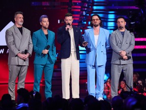 From left, Joey Fatone, Lance Bass, Justin Timberlake, JC Chasez and Chris Kirkpatrick of NSYNC speak onstage the 2023 MTV Video Music Awards in New Jersey.