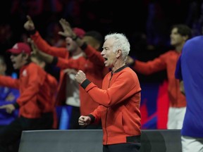 Team World's Captain John McEnroe cheers for teammate Frances Tiafoe during his singles tennis match against Team Europe's Stefanos Tsitsipas on the third day of the Laver Cup tennis tournament at the O2 arena in London, Sunday, Sept. 25, 2022. McEnroe is sharing his frustration over what he see as a lack of cooperation and care from tennis organization officials when it comes to the Laver Cup.