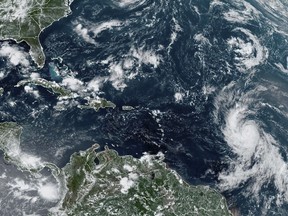 Residents of Canada's East Coast are keeping a close watch on hurricane Lee. Recently released computer-generated forecasts suggest the powerful storm is headed for the Maritimes late next week. But an expert says these long-range 'spaghetti' models are of little use at this stage. This Wednesday, Sept. 6, 2023, satellite image provided by the National Oceanic and Atmospheric Administration shows Hurricane Lee, right, off in the central tropical Atlantic Ocean. (NOAA via AP)