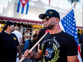Henry "Enrique" Tarrio, leader of The Proud Boys, holds an US flags during a protest showing support for Cubans demonstrating against their government, in Miami, Florida, on July 16, 2021. Enrique Tarrio, the former leader of the far-right Proud Boys militia, was sentenced to 22 years in prison on September 5, 2023, the stiffest sentence handed out so far for the 2021 attack on the US Capitol.