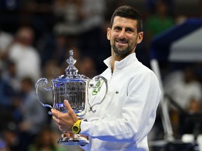 Serbia's Novak Djokovic poses with the trophy after defeating Russia's Daniil Medvedev in the US Open tennis tournament men's singles final match at the USTA Billie Jean King National Tennis Center in New York on September 10, 2023.