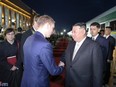 North Korean leader Kim Jong Un shakes hands with Alexander Kozlov, Russia's minister of natural resources.