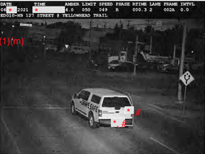 A marked photo radar vehicle is pictured just before it runs a red light at Yellowhead Trail and 127 Street in Edmonton in June 2021.