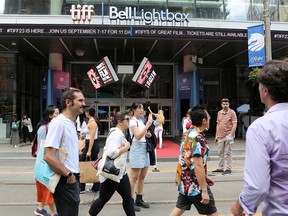 People walk outside the TIFF Bell Lightbox building.