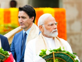 Prime Minister Justin Trudeau walks past Indian Prime Minister Narendra Modi.
