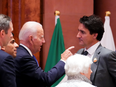 Prime Minister Justin Trudeau and U.S. President Joe Biden speak as they arrive to take part in a working session at the G20 Summit in New Delhi, India.