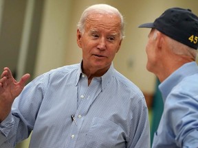 biden Joe Biden talks to U.S. Senator Rick Scott, a Republican from Florida, who is wearing a Trump 45 hat in Live Oak, Florida