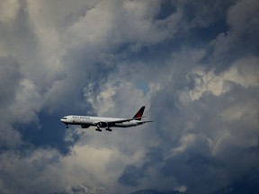 Air Canada says it has repaid about $589 million in debt that it used to buy aircraft. An Air Canada Boeing 777 is seen on approach to land at Vancouver International Airport in Richmond, B.C., on Tuesday, April 11, 2023.