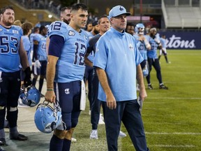 Toronto Argonauts quarterback Chad Kelly (12) and head coach Ryan Dinwiddie look on during second half CFL football action against the Ottawa Redblacks in Toronto, on Sunday, August 13, 2023.