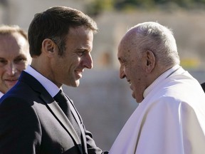 Pope Francis is welcomed by French President Emmanuel Macron in Marseille, France, Saturday, Sept. 23, 2023.