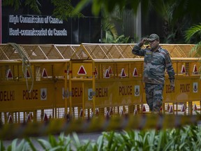 An Indian paramilitary soldier stands guard next to a police barricade outside the Canadian High Commission in New Delhi, India, Tuesday, Sept. 19, 2023. Tensions between India and Canada are high after Prime Minister Justin Trudeau's government expelled a top Indian diplomat and accused India of having links to the assassination in Canada of Sikh leader Hardeep Singh Nijjar, a strong supporter of an independent Sikh homeland.