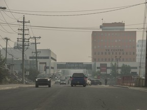 Heavy smoke from nearby wildfires fills the sky in Yellowknife on Tuesday, August 15, 2023. Residents of Yellowknife and a nearby First Nation have been told they'll be allowed home as early as Sept. 6, barring any increase in wildfire risk.