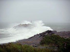 Waves crash against a breakwater in Port Maitland, N.S. as post-tropical cyclone Lee approaches on Saturday, Sept. 16, 2023.