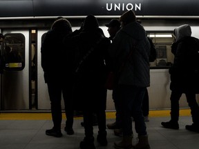 While many workplaces have shifted to hybrid setups coming out of the pandemic, employment lawyers say workers should be cautious about using the added flexibility to work from home when feeling sick. Passengers wait to board a subway car in Toronto on Friday, January 27, 2023.