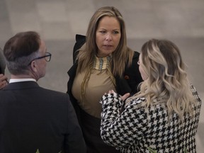 Lich, centre, chats with Drew Barnes MLA Cypress Medicine Hat, left, and others before the 2023 budget, in Edmonton