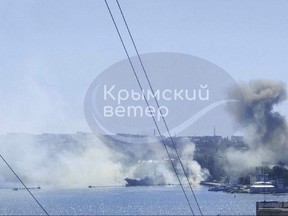This image taken from UGC video shows smoke rising from the headquarters of Russia's Black Sea Fleet in Sevastopol, Crimea, Friday Sept. 22, 2023. Ukraine carried out a fiery missile strike Friday on the main headquarters of Russia's Black Sea Fleet and one serviceman was missing, the Russian Defense Ministry said (Crimean Telegram channel via AP)