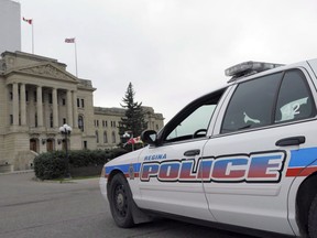 A Regina Police Service car idles at the legislative building in Regina, Saskatchewan on Wednesday, October 22, 2014. Regina police say they've arrested and charged a man with endangering lives after he allegedly cut the lines on multiple gas meters -- at one point even threatening a fire inspector who investigators say caught him in the act.