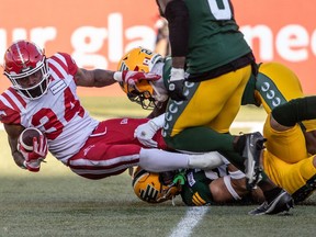 Calgary Stampeders' LeVante Bellamy (34) is tackled by the Edmonton Elks during first half CFL action in Edmonton on Saturday, September 9, 2023.