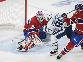 Toronto Maple Leafs' Nicholas Robertson (89) scores against Montreal Canadiens goaltender Samuel Montembeault as Canadiens' William Trudeau defends during second period NHL preseason hockey action in Montreal, Saturday, Sept. 30, 2023.
