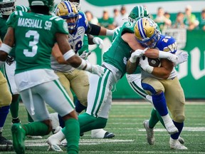 Winnipeg Blue Bombers running back Brady Oliveira (20) runs the football against Saskatchewan Roughriders during the first half of CFL Labour Day Classic football action in Regina, Sunday, Sept. 3, 2023.