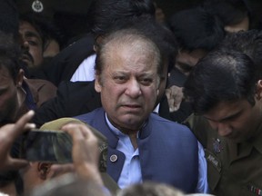 FILE - Former Pakistani Prime Minister Nawaz Sharif leaves a court in Lahore, Pakistan, on Oct. 8, 2018. Sharif is claiming that the country's former powerful military and spy chiefs orchestrated his ouster in 2017, when he was forced to step down after being convicted of corruption. Sharif spoke on Monday, Sept. 18, 2023, to leaders of his Pakistan Muslim League party via a video link from London, where he has been living in self-imposed exile since 2019.