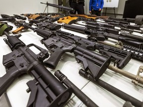FILE - A variety of military-style semi-automatic rifles obtained during a buy back program are displayed at Los Angeles police headquarters on Dec. 27, 2012, in Los Angeles. A federal judge on Friday, Sept. 22, 2023, struck down a California law banning high-capacity magazines.