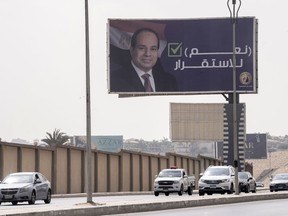 FILE - Vehicles pass under a billboard supporting Egyptian President Abdel Fattah el-Sissi for the coming presidential elections, erected by Egypt's political party of Homat Watan, the Protectors of the Nation, in Cairo, Egypt, on Sept. 4, 2023. Arabic reads, "yes for stability." Egypt will hold a presidential election over three days in December, officials announced Monday, Sept. 25, 2023 with President Abdel Fattah el-Sissi highly likely to prolong his stay in power until 2030.