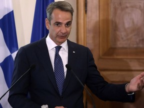 FILE - Greek Prime Minister Kyriakos Mitsotakis addresses the media at the Presidential Palace in Nicosia, Cyprus, on Monday, July 31, 2023. Torrential rain sweeping across central Greece has damaged roads, flooded homes and caused power outages on the island of Evia. "I will restate the obvious: The frequency of (weather) assaults due to the climate crisis is something that requires us to integrate civil protection (in our response)," Prime Minister Kyriakos Mitsotakis told a Cabinet meeting Wednesday, Sept. 27.
