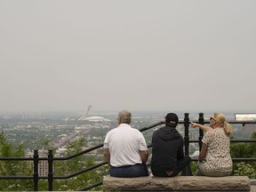 Montreal plans to fundamentally alter its namesake mountain. A group of tourists look east from a lookout on Mount Royal on Monday, June 5, 2023.