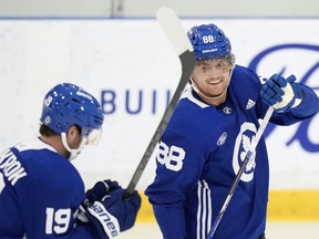 Toronto Maple Leafs forward William Nylander, right, smiles at teammate Calle Jarnkrok at practice during the opening week of their NHL training camp in Toronto, Thursday, Sept. 21, 2023.