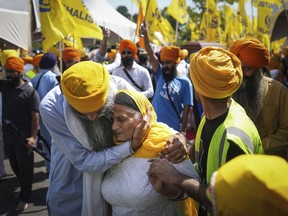 FILE - A woman is consoled as people mourn Sikh community leader and temple president Hardeep Singh Nijjar during Antim Darshan, the first part of day-long funeral services for him, in Surrey, British Columbia, Sunday, June 25, 2023. Nijjar was gunned down in his vehicle while leaving the Guru Nanak Sikh Gurdwara Sahib parking lot. The September 2023 accusation by Canadian Prime Minister Justin Trudeau that India may have been behind the assassination of Nijjar, a Sikh separatist leader, has raised several complex questions about the nature of Sikh activism in the North American diaspora.
