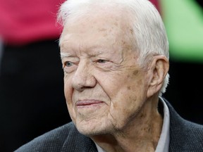 FILE - Former President Jimmy Carter sits on the Atlanta Falcons bench before the first half of an NFL football game between the Atlanta Falcons and the San Diego Chargers, Oct. 23, 2016, in Atlanta. Former President Carter, on Saturday Sept. 23 2023 made a surprise appearance at the Plains Peanut Festival in their Georgia hometown, the Carter Center wrote in a social media post on X, formerly known as Twitter.