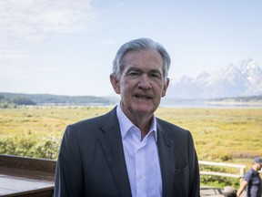 FILE - Federal Reserve Chairman Jerome Powell takes a break outside of Jackson Lake Lodge during the Jackson Hole Economic Symposium near Moran in Grand Teton National Park, Wyo., Aug. 25, 2023. Powell swore in three members of the central bank's governing board Wednesday, Sept. 13, including Philip Jefferson as vice chair and Adriana Kugler to fill a vacant seat as the central bank's first Latina governor.