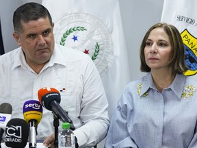 Panama's Security Minister Juan Pino, left, and Panama's National Immigration Authority Director Samira Gozaine listen to questions during a press conference where they announced migration measures in Panama City, Friday, Sept. 8, 2023. Panama will increase infrastructure in the jungle area along its shared border with Colombia known as the Darien Gap -- as well as ramp up deportations -- to contain a record-breaking flow of migrants passing through there this year, Gozaine said Friday.