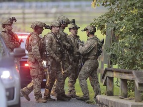 Pennsylvania State police search the woods and a creek in Pennsbury Township, Pa., on Tuesday, Sept. 5, 2023. Murderer Danelo Cavalcante was able to escape a prison yard in suburban Pennsylvania last week by climbing up a wall and over razor wire, officials said at a news conference Wednesday.