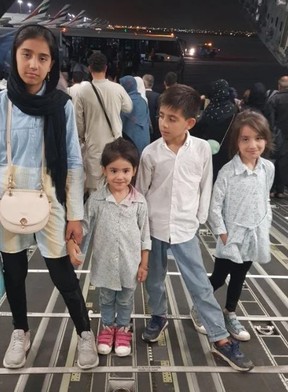 Four of Ahmad Rahimi’s five children in the back of an Royal Air Force A-400 cargo plane, just arrived in Dubai from Kabul, on Aug. 21 2021.