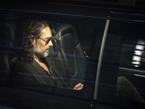 Russell Brand in a car.
