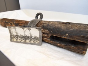 An artifact from the USS Maine, recently donated to the curatorial collection of Arlington National Cemetery, is paired with a historical stereographic image of the wrecked battleship.