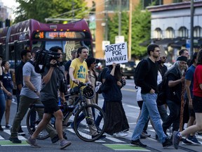 Protesters march through downtown Seattle after body camera footage was released of a Seattle police officer joking about the death of Jaahnavi Kandula, a 23-year-old woman hit and killed in January by officer Kevin Dave in a police cruiser, Thursday, Sept. 14, 2023, in Seattle.