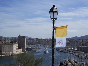 A Vatican flag is set up in the harbor of Marseille, southern France, the day Pope Francis arrives for a two-day visit, Friday, Sept. 22, 2023, when he will join Catholic bishops from the Mediterranean region on discussions that will largely focus on migration.