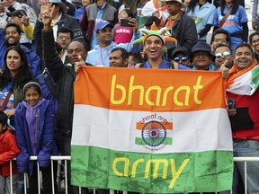 FILE- Indian cricket fans wait for the start of the Cricket World Cup match between India and New Zealand at Trent Bridge in Nottingham, Thursday, June 13, 2019. India has two official names: India, a nomenclature used and accepted in English communication worldwide, and a Sanskrit and Hindi appellation that is "Bharat." This choice of name is now under spotlight, with Prime Minister Narendra Modi's government making calls that Indians should rather call their country Bharat and not India.