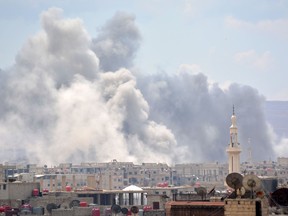 A picture taken on April 22, 2018, shows smoke billowing from the Palestinian camp of Yarmouk, south of the Syrian capital Damascus, during regime strikes targeting the Islamic State group in the camp.