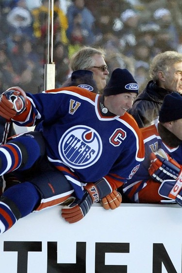 Wayne Gretzky leaps off the bench during the MegaStars game at the Heritage Classic on Nov. 22, 2003.