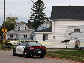 Police tape and vehicles surround a crime scene in Sault Ste. Marie, Ont. on Tuesday, Oct. 24, 2023. Five people, including three children and a shooter, were found dead in the northern Ontario city after shootings at two homes, police said Tuesday, calling what happened a tragic case of intimate partner violence.