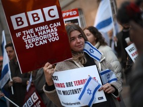 Protesters holding placards and Israeli flags join a gathering outside the headquarters of the BBC (British Broadcasting Corporation) in London on Oct. 16, 2023.
