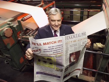 Conrad Black looks over the first press run of the Financial Post as a section of the National Post