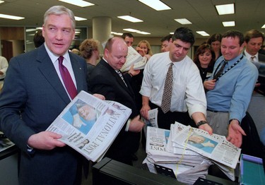 Founder Conrad Black hands out copies of the National Post's first edition.