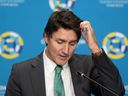 Prime Minister Justin Trudeau scratches his head as he delivers remarks at a Caribbean trade summit in Ottawa on Wednesday, as his counterparts from the United States, Britain and Germany were visiting the Middle East to offer their support to Israel.
