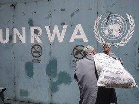 A Palestinian man walks by the UN Relief and Works Agency's offices in Gaza City.